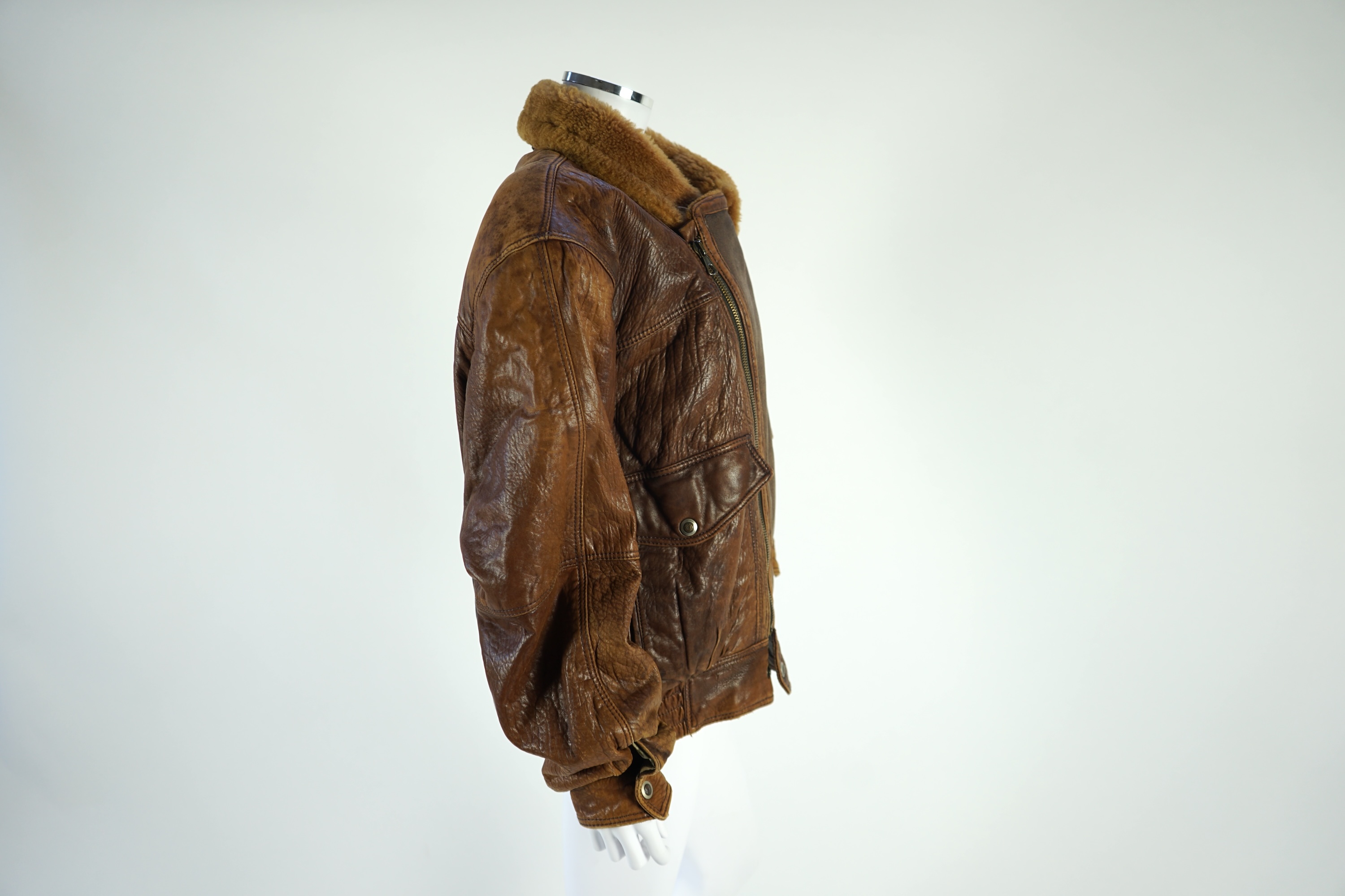 A gentleman's vintage brown leather bomber jacket made by The King, size unknown.